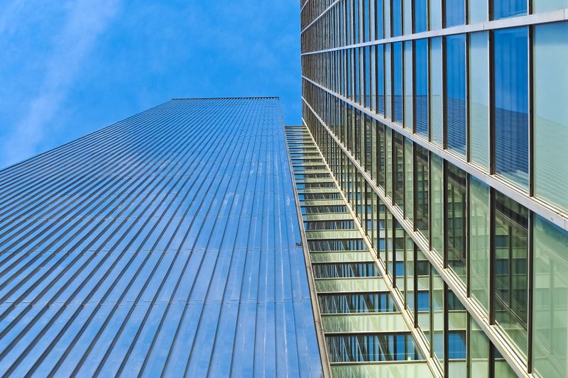 Glass office towers viewed from below — illustrative image
