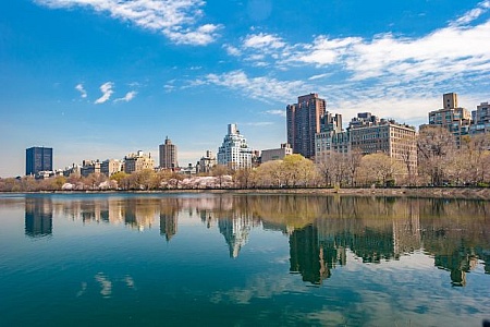 City skyline reflected in an urban lake — illustrative image